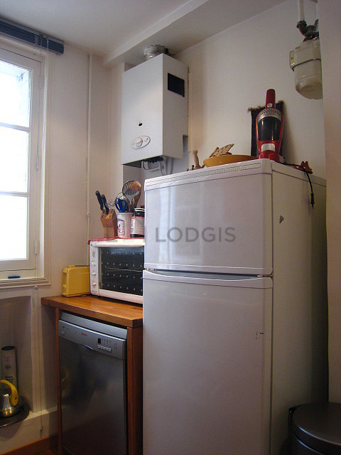 Kitchen equipped with dishwasher, hob, refrigerator, crockery