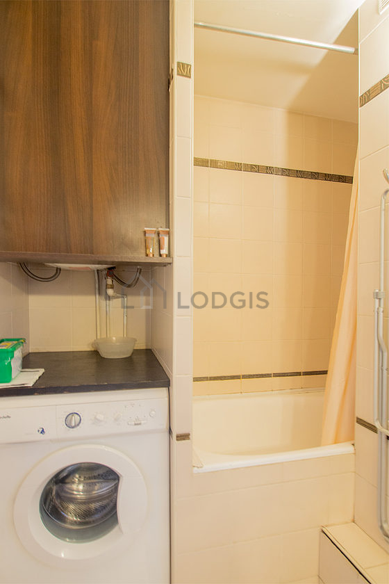 Bathroom equipped with washing machine, bath towels