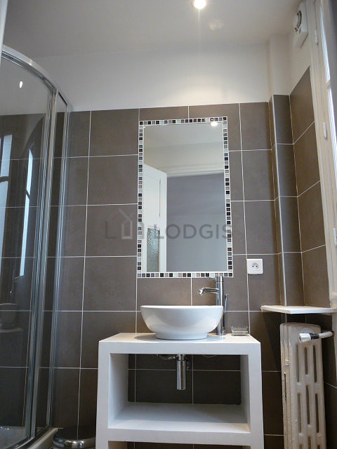 Agréable salle de bain claire avec fenêtres et du carrelage au sol