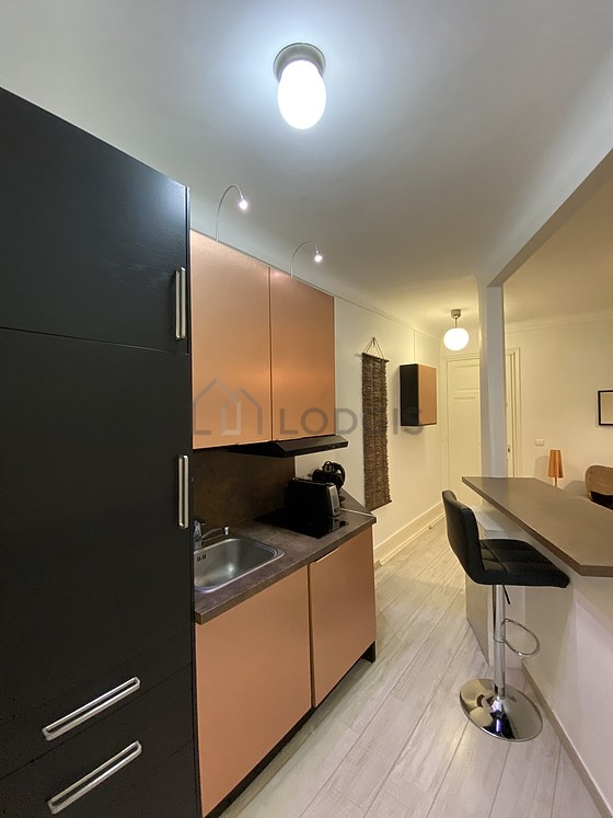 Beautiful kitchenopens on the living room with wooden floor