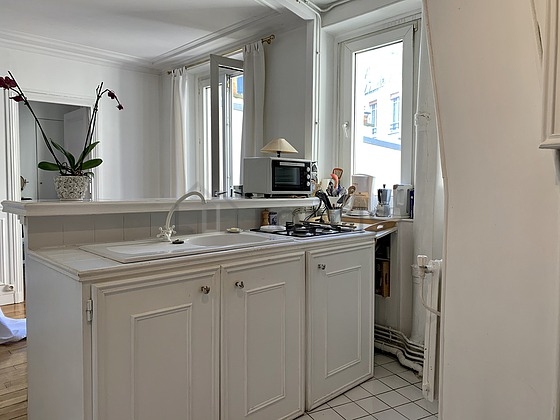 Kitchen equipped with washing machine, refrigerator, freezer, crockery