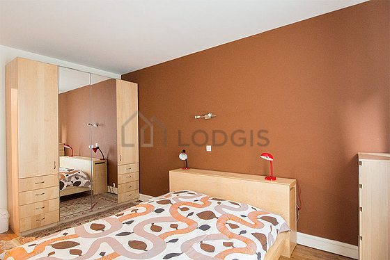 Bright bedroom equipped with wardrobe, cupboard, bedside table