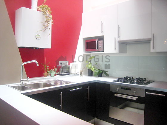 Kitchen equipped with washing machine, refrigerator, extractor hood, crockery