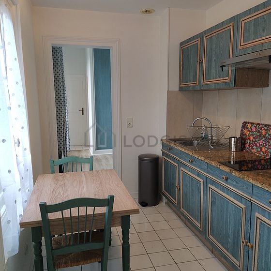 Kitchen where you can have dinner for 3 person(s) equipped with hob, refrigerator, freezer, extractor hood