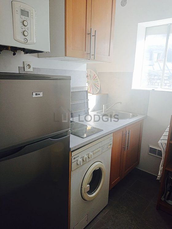Kitchen equipped with washing machine, refrigerator, crockery