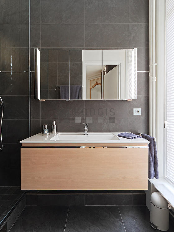 Pleasant and bright bathroom with windows and with tile floor