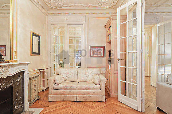 Very beautiful office with woodenfloor furnished with sofa, bookcase, shelves
