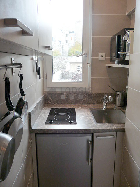Kitchen equipped with hob, refrigerator, crockery
