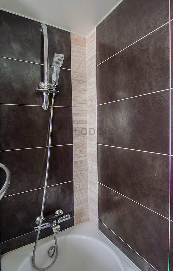 Bathroom equipped with washing machine, dryer, bath towels