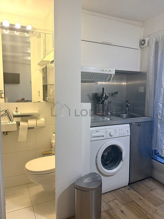 Kitchen equipped with washing machine, refrigerator, freezer, crockery