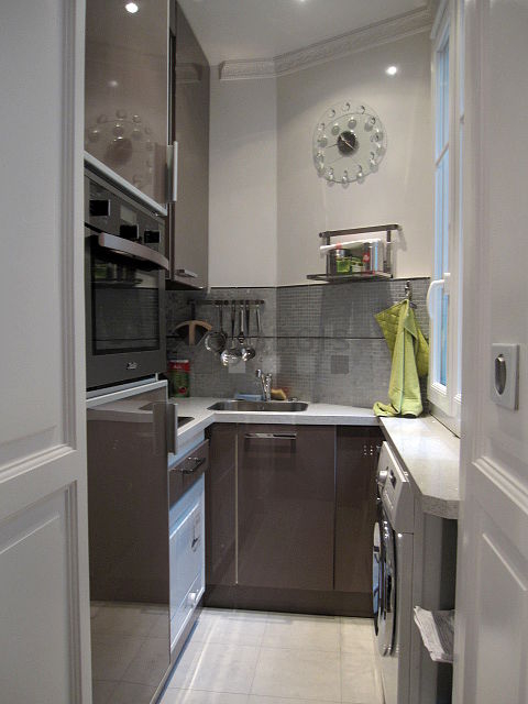 Kitchen equipped with washing machine, dryer, refrigerator, extractor hood