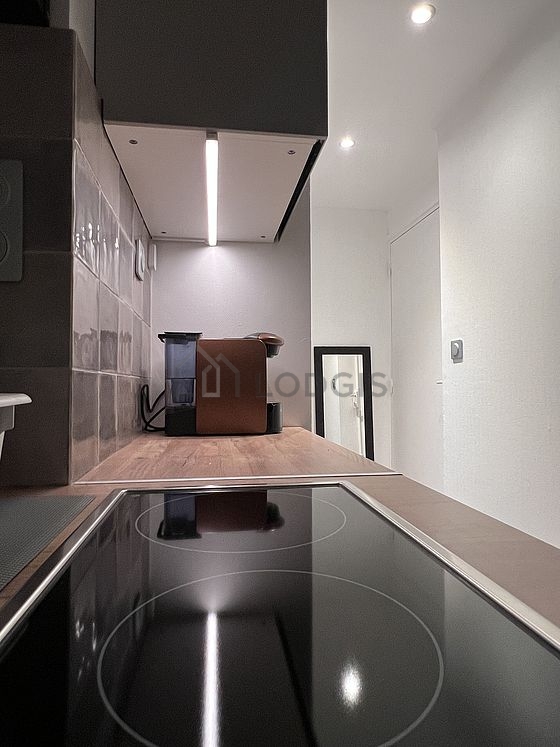 Kitchen equipped with hob, refrigerator, freezer, crockery