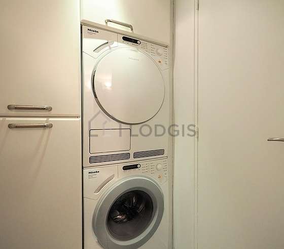 Laundry room with tilefloor and equipped with washing machine, dryer