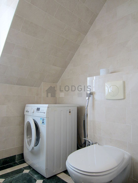 Bathroom equipped with washing machine, dryer, bath towels