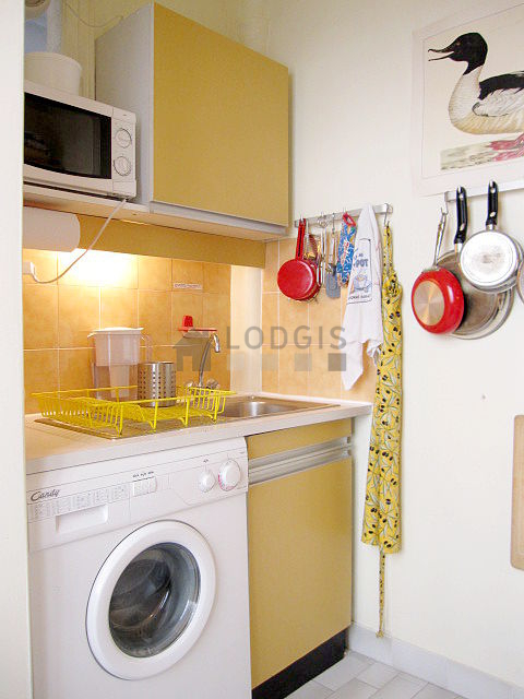 Kitchen equipped with washing machine, refrigerator, crockery