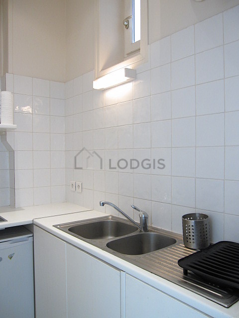 Kitchen equipped with hob, refrigerator, crockery