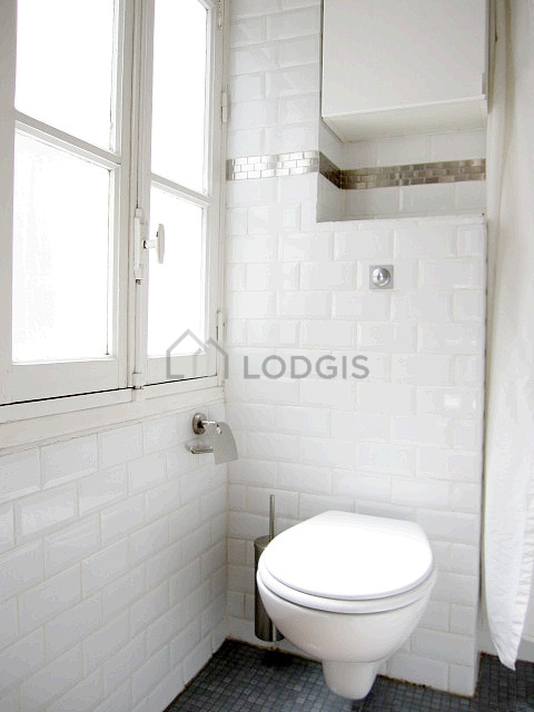 Beautiful and bright bathroom with windows and with tile floor
