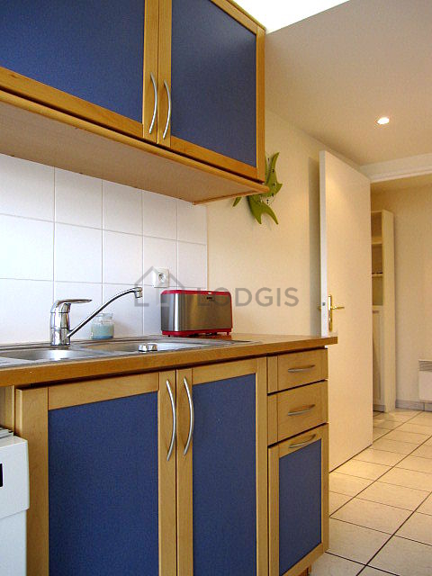 Kitchen equipped with dishwasher, hob, refrigerator, crockery