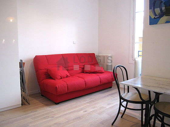 Bright living room furnished with cupboard, 2 chair(s)