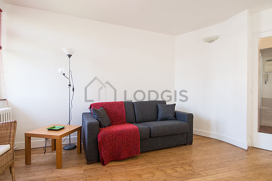 Living room with windows and balcony facing the road