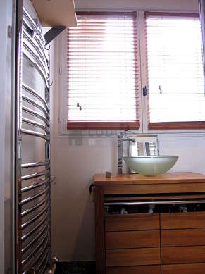 Bright bathroom with double-glazed windows and with tilefloor