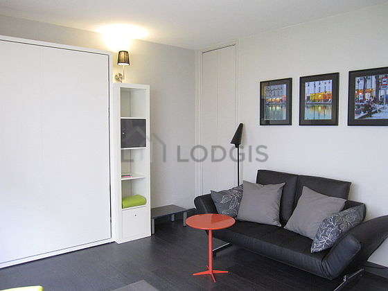 Bright living room furnished with cupboard, 2 chair(s)