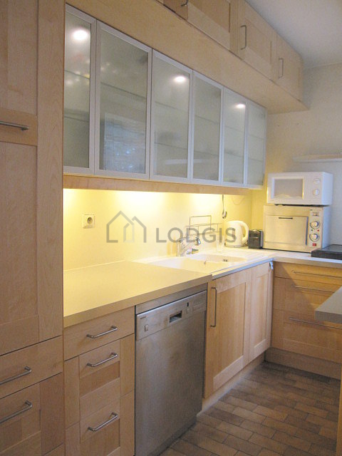 Kitchen equipped with dishwasher, hob, refrigerator, crockery