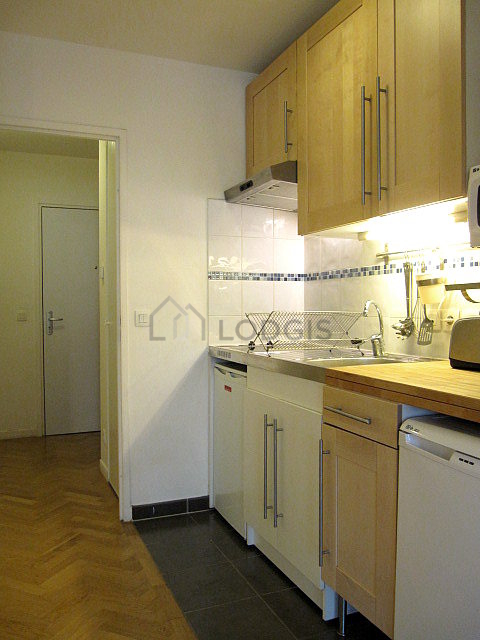Kitchen equipped with hob, refrigerator, extractor hood, crockery