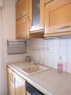 Kitchen equipped with washing machine, dryer, extractor hood, crockery