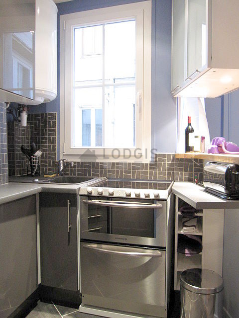 Bright kitchen with double-glazed windows facing the courtyard