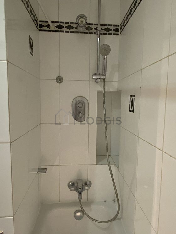 Bathroom equipped with washing machine, dryer, bath towels