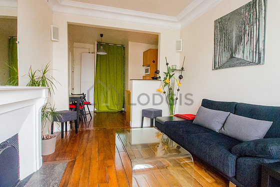 Living room with double-glazed windows and balcony facing the road