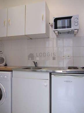 Kitchen equipped with washing machine, refrigerator, freezer, crockery