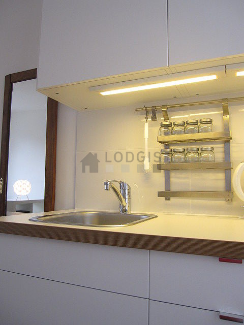 Kitchen equipped with hob, refrigerator, freezer, crockery