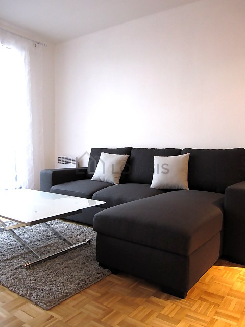 Living room with double-glazed windows and balcony facing the road