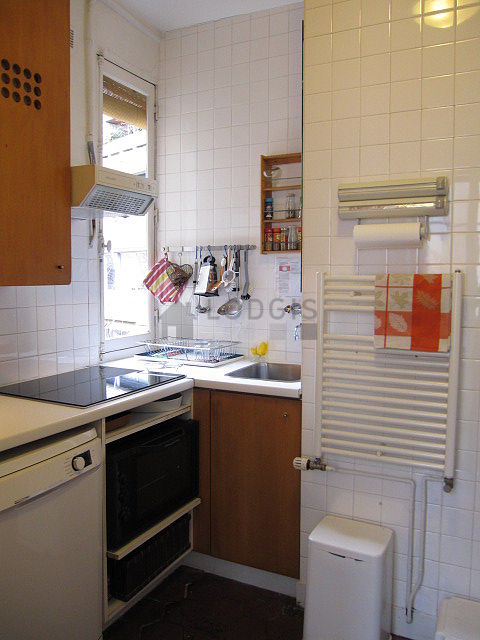 Kitchen equipped with dishwasher, hob, refrigerator, extractor hood