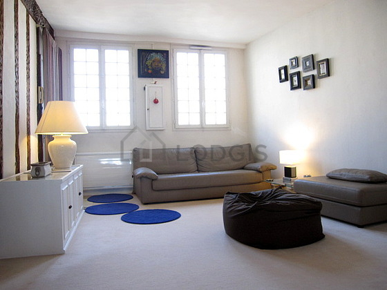 Quiet living room furnished with tv, wardrobe, cupboard, 3 chair(s)