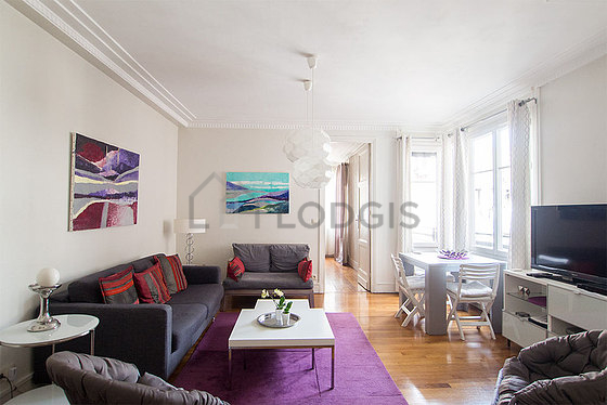 Living room with double-glazed windows and balcony facing the courtyard