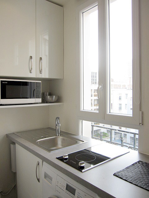 Kitchen equipped with washing machine, dryer, crockery