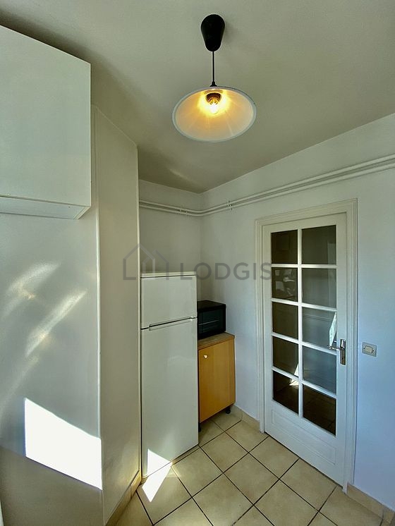 Kitchen equipped with washing machine, refrigerator, crockery