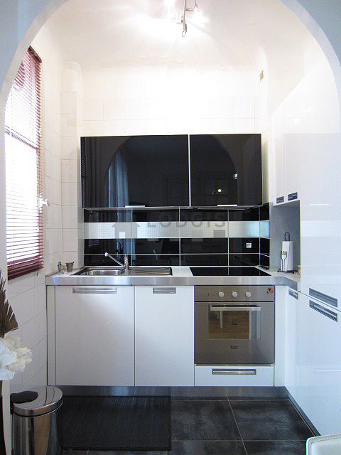 Kitchen equipped with dishwasher, hob, refrigerator, extractor hood