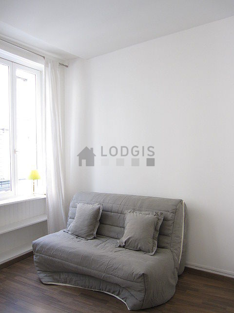 Living room with double-glazed windows facing the road