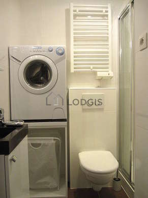 Bathroom equipped with washing machine, cupboard