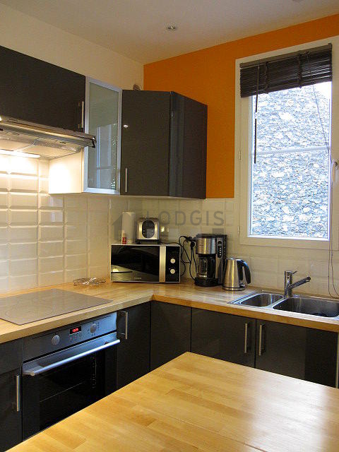 Kitchen equipped with dishwasher, hob, refrigerator, extractor hood