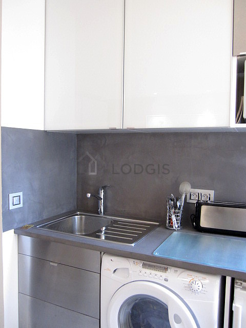 Kitchen equipped with washing machine, dryer, refrigerator, crockery