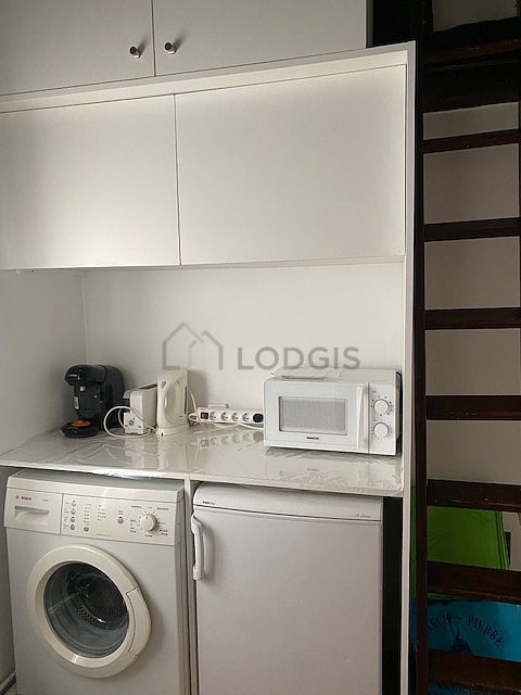 Kitchen equipped with washing machine, refrigerator, crockery