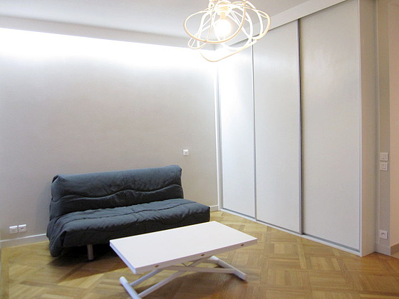 Living room with double-glazed windows and balcony facing the road