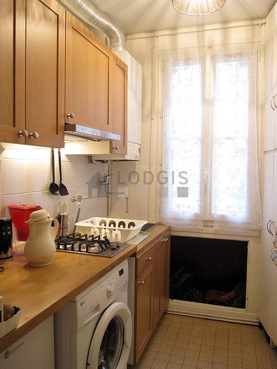 Kitchen equipped with washing machine, refrigerator, freezer, extractor hood