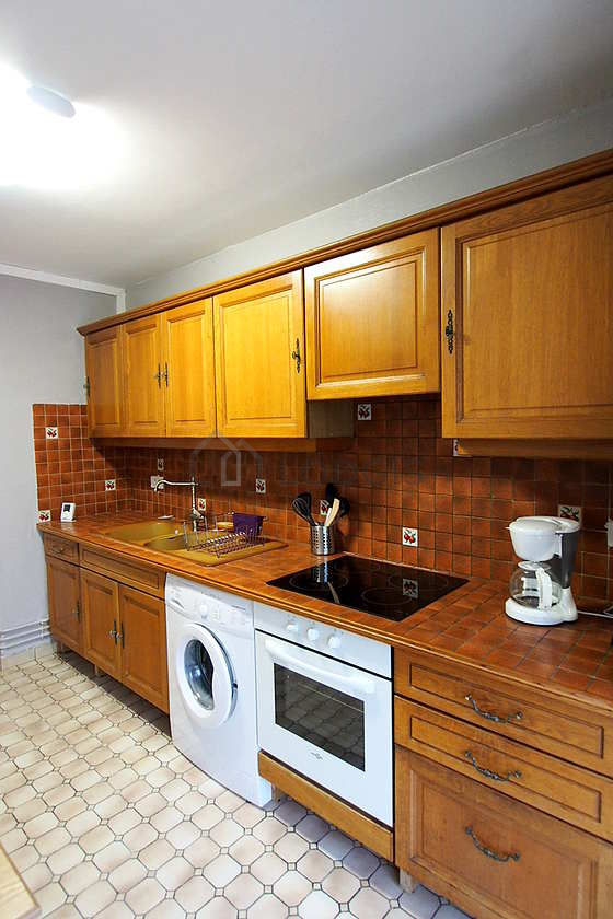 Kitchen where you can have dinner for 2 person(s) equipped with washing machine, refrigerator, extractor hood, crockery