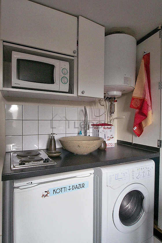Kitchen equipped with washing machine, refrigerator, freezer, crockery